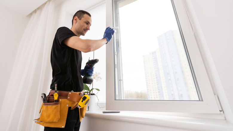 Tradesman installing heat-efficient windows