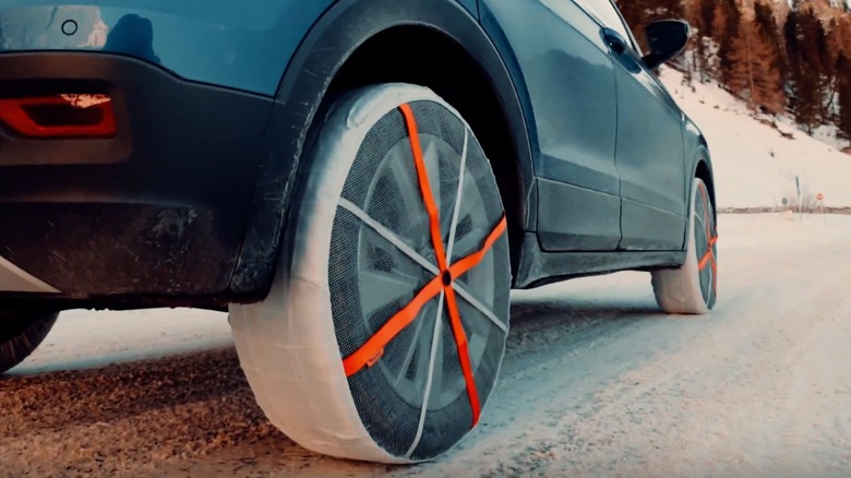 AutoSock Snow Socks installed on an SUV in the snow