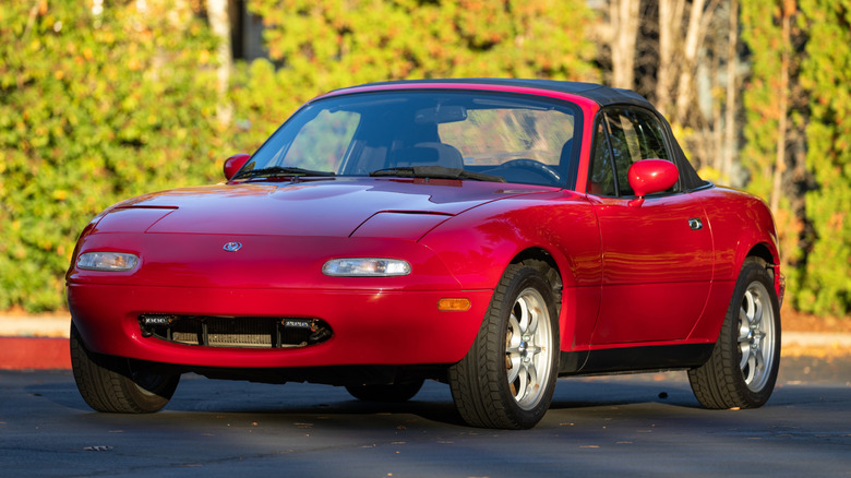 A 1994 classic red Mazda Miata car parked by the road