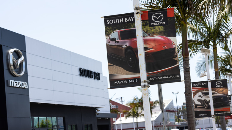 The South Bay Mazda Dealership with a poster of MX-5 Miata