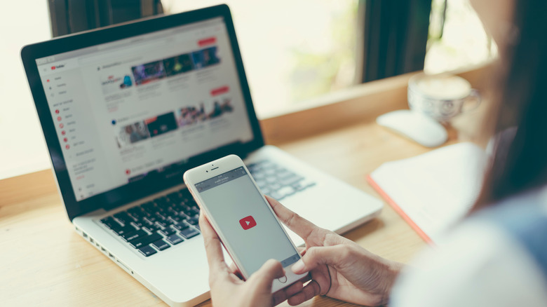 Person using YouTube on their laptop and phone