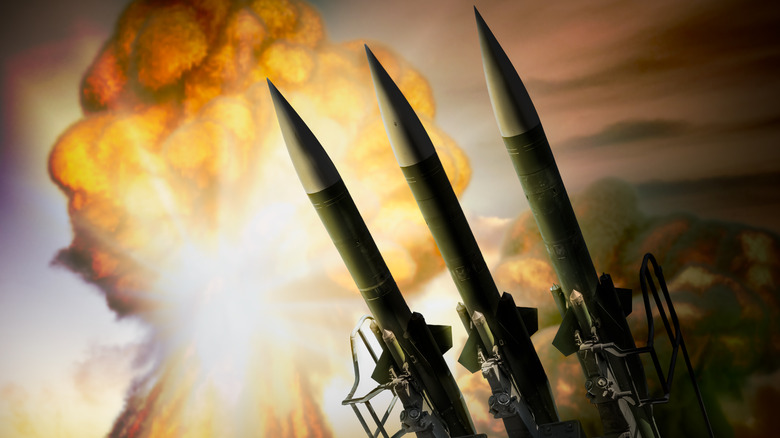 Nuclear missiles with mushroom cloud in background