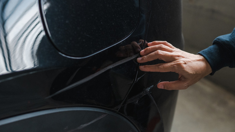 Scratches on the rear bumper of a black car