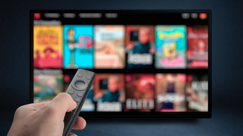 Person holding remote on Netflix