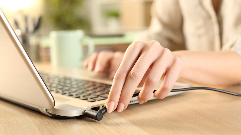 woman unplugging her laptop