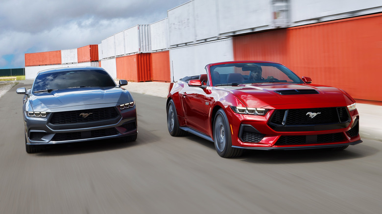 Action shot of a Ford Mustang Fastback and Convertible on a paved surface
