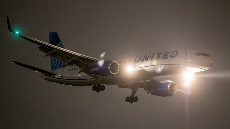 plane with lights on at night