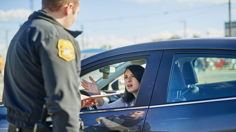 A woman getting a traffic ticket