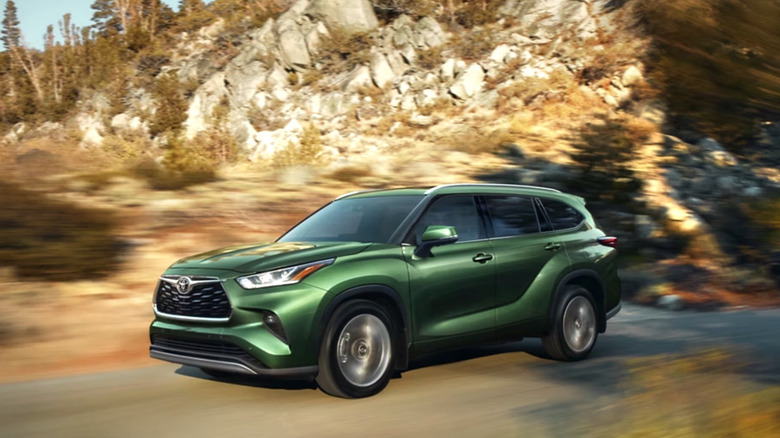 Toyota Highlander driving through mountain landscape
