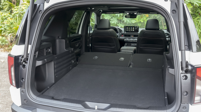 Rear view of Honda Passport cargo area with rear hatch open, showing rear seat folded down