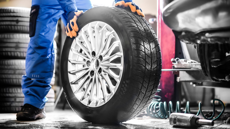 Mechanic holding tire