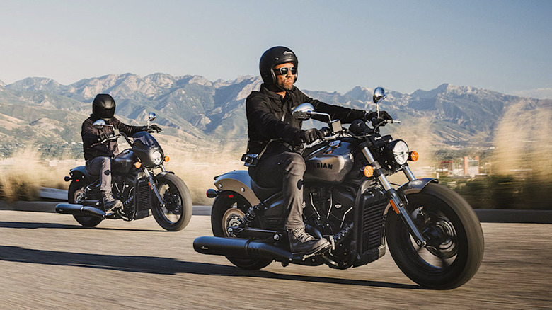Two riders on Indian Motorcycles with mountain backdrop