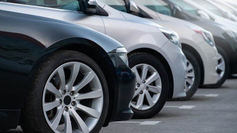 Close-up of car front wheels parked in a lot