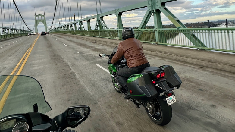Kawasaki Ninja H2 SX riding over a bridge