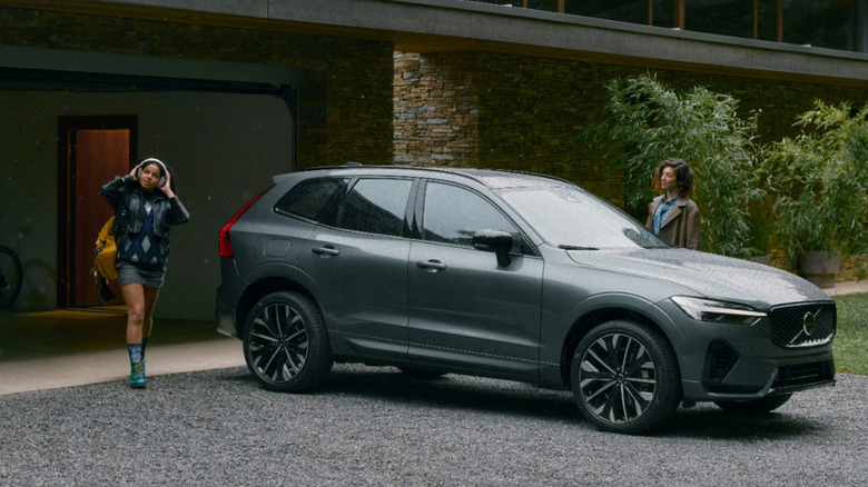 A Volvo car parked outside a family house