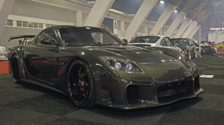 Green Mazda RX7 FD with Veilsize body kit in garage