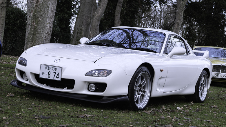 White Mazda RX7 parked in grass at car show