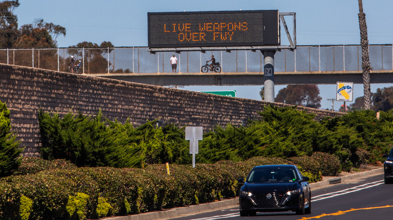 Sign warning drivers of live munitions over highway