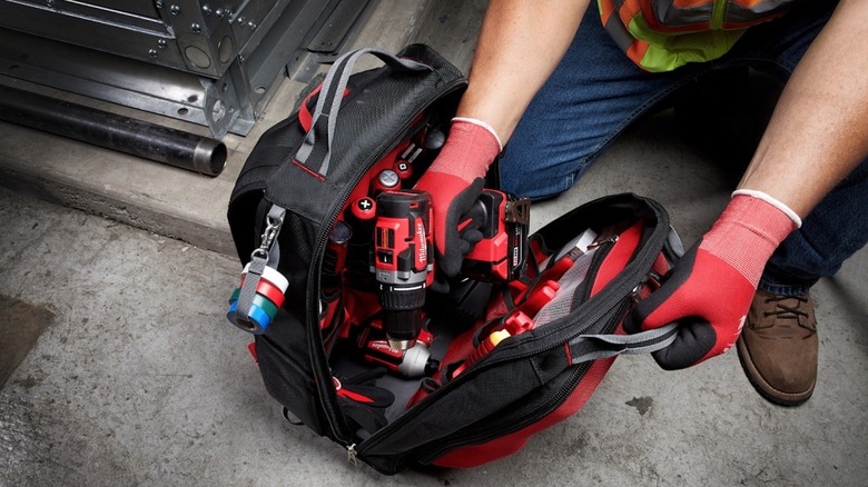 Person using Milwaukee Packout Backpack