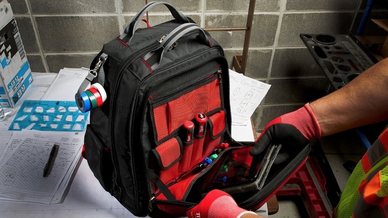 Person using Milwaukee Packout Backpack