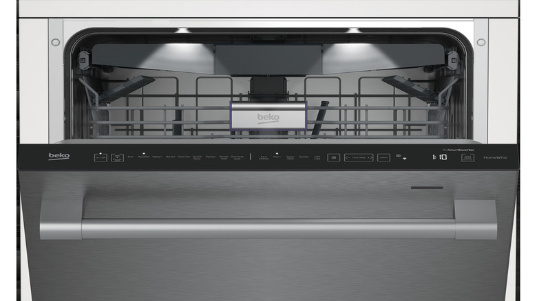 An open Beko built-in dishwasher with a stainless steel door and white surround.