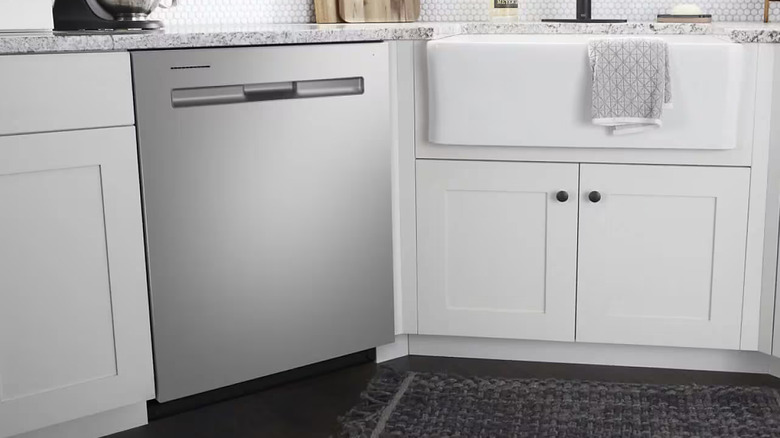 A Maytag stainless steel built-in diswasher with a towel bar handle.