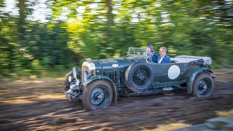 A Bentley 4 1/2 Litre on a muddy track, front 3/4 view