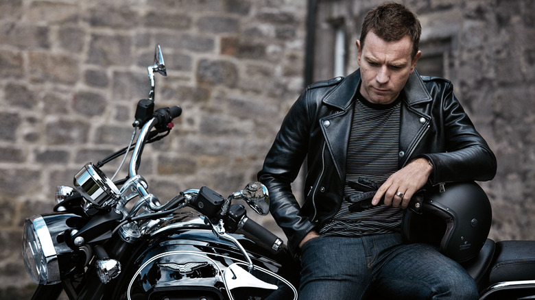 Ewan McGregor sitting on a motorcycle