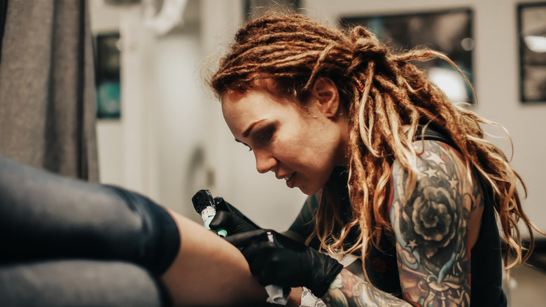 Tattoo artist working