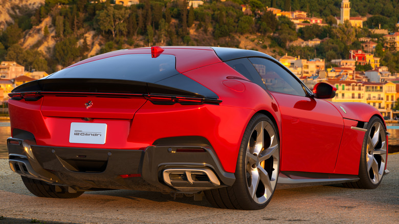 A bright red Ferrari 12Cilindri grand tourer parked seaside.