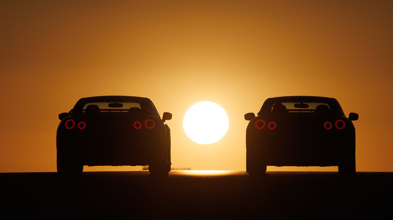 Two Nissan R35 GT-Rs at sunset