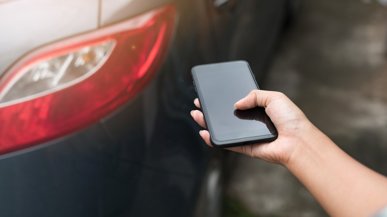 Car smartphone in hand
