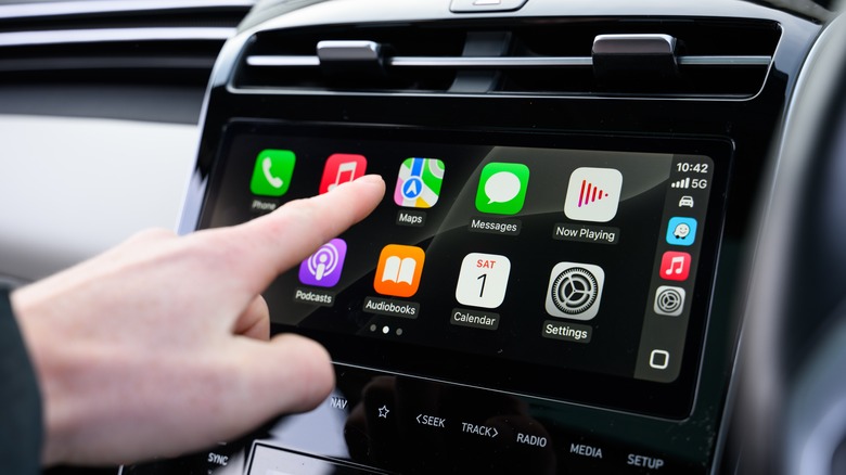 Hand Interacting with Apple CarPlay in Vehicle