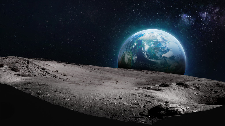 The moon's surface and Earth in the distance