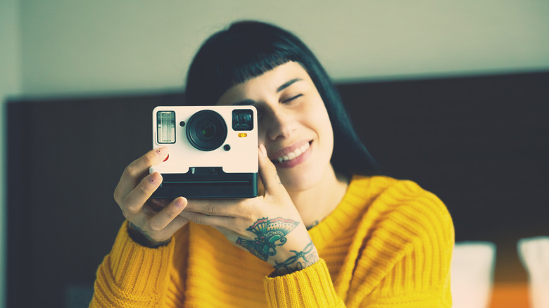 woman with polaroid camera