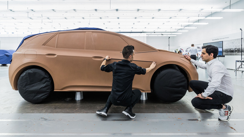inspecting full size clay car model