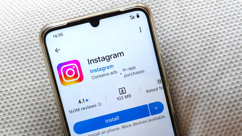 Close-up smartphone showing Instagram app page on Google Play Store with modern white background style.