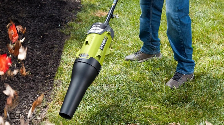 Using a Ryobi Expand-It Leaf Blower attachment to clear leaves.