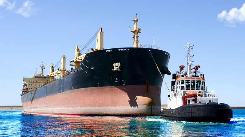 Tugboat towing large ship