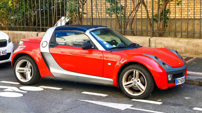 Red Smart Roadster Coupe parked on street