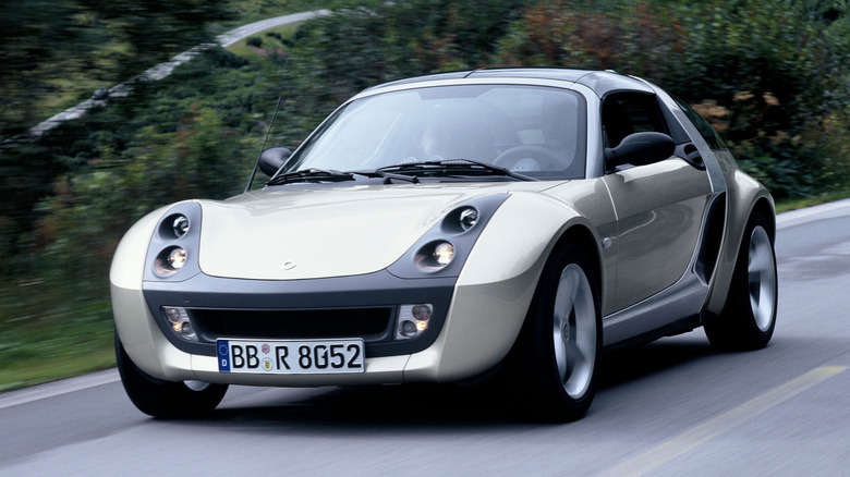 Silver Smart Roadster driving on country road