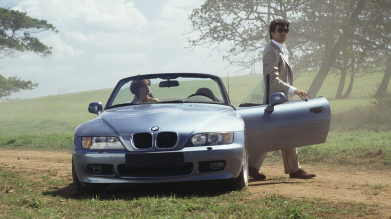 Pierce Brosnan standing beside BMW Z3 Roadster