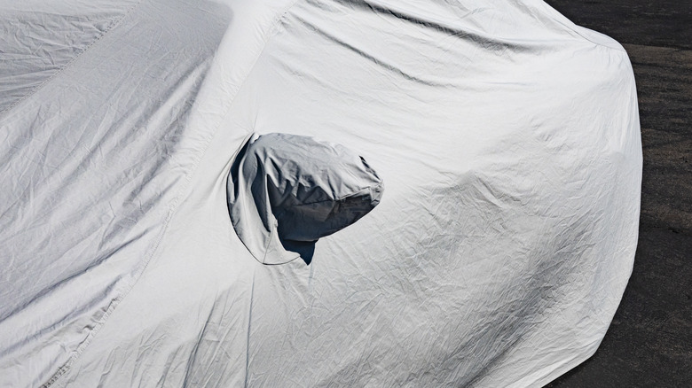 Car covered with a white cover