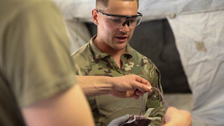 US Army members with blood bag.