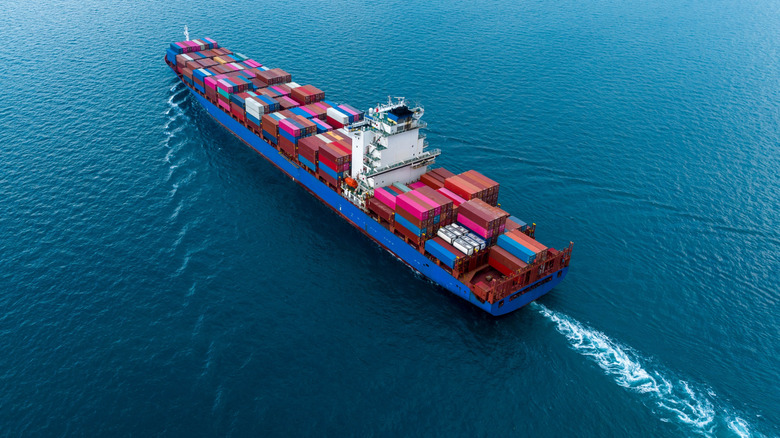 Aerial view of a cargo ship gliding on water