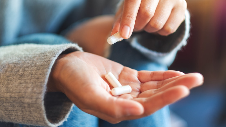person holding medicinal pills