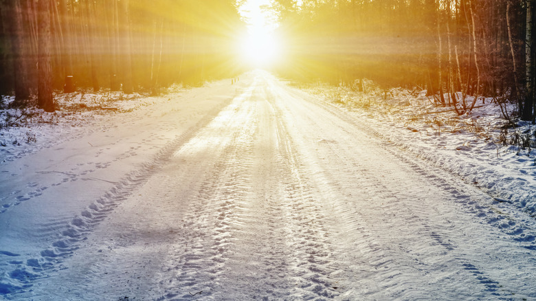 Bright sun and snow on road