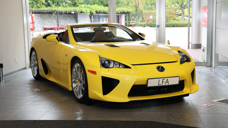 Front 3/4 view of yellow Lexus LFA Spyder in museum lobby