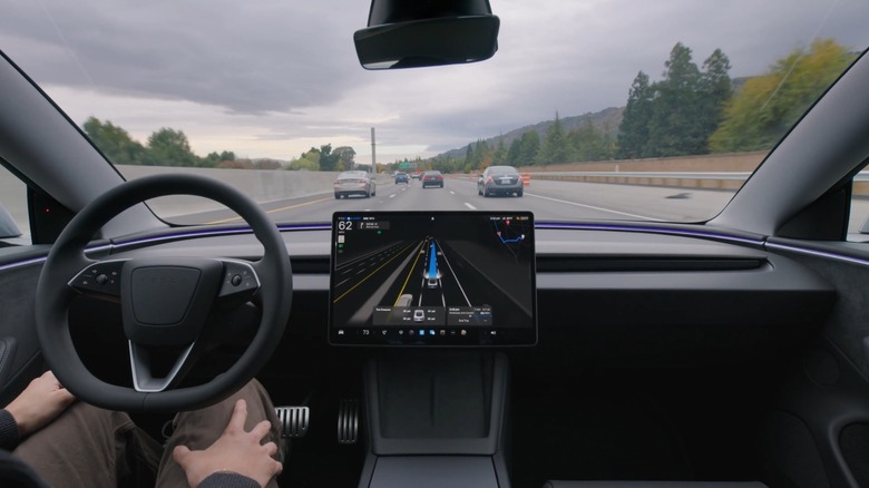 Tesla driving in supervised FSD mode down a highway