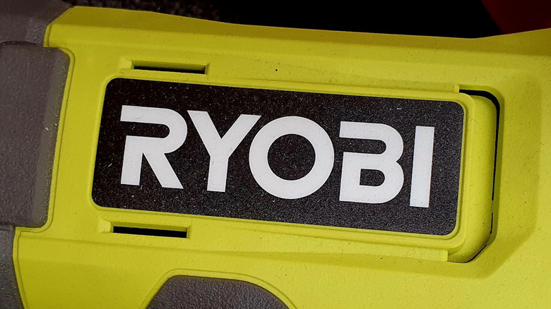 The Ryobi logo on the side of a tool.